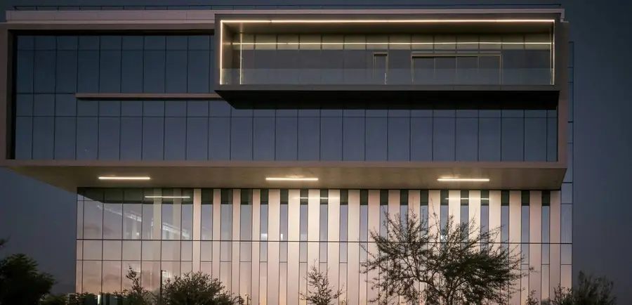 Modern commercial office building exterior at dusk