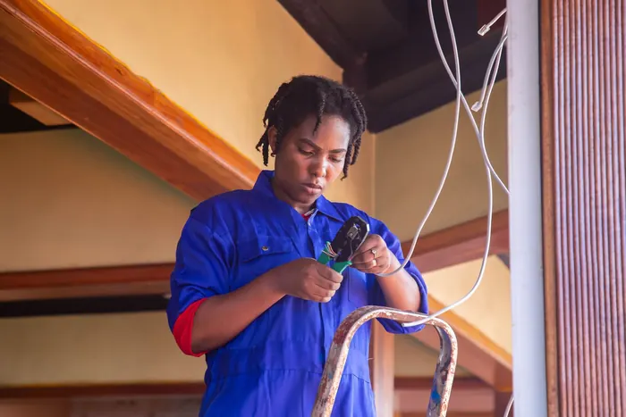 Technician on a ladder with cable